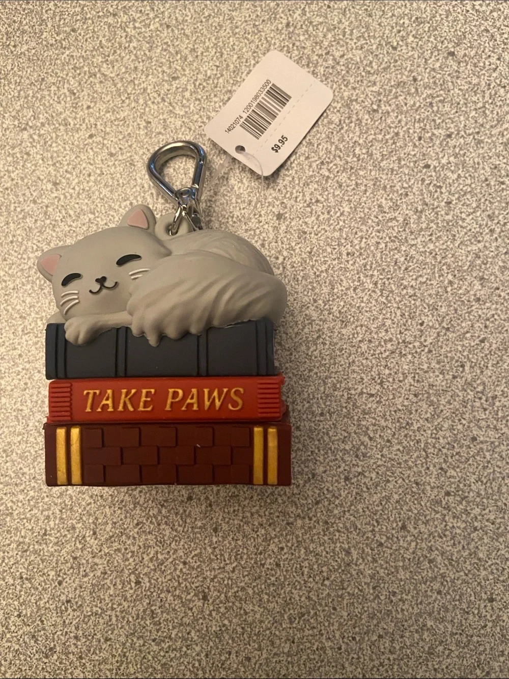Cat on top of book hand sanitizer holder